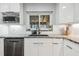 Bright kitchen with a stainless steel dishwasher, white cabinets, subway tile backsplash, and a black faucet at 1111 Lakemont Dr, Valrico, FL 33594