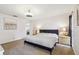 Main bedroom featuring a large bed, ceiling fan, and two nightstands at 1111 Lakemont Dr, Valrico, FL 33594