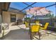 Screened-in patio with outdoor dining area and shade umbrella at 1111 Lakemont Dr, Valrico, FL 33594