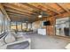 Inviting sunroom features natural wood paneling, a fan, and a door to the outdoor patio at 1111 Lakemont Dr, Valrico, FL 33594