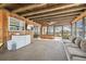 Cozy sunroom with wood paneled walls, a large couch, and views of the backyard at 1111 Lakemont Dr, Valrico, FL 33594