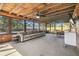 Relaxing sun room with wood ceilings, comfortable seating, and views of the backyard at 1111 Lakemont Dr, Valrico, FL 33594