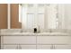 Bathroom featuring double sink vanity with bright mirror and white cabinets at 11118 E 65Th Ter, Palmetto, FL 34221