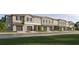 Row of townhomes with garages, neutral paint, stone accents, and well-maintained landscaping at 11118 E 65Th Ter, Palmetto, FL 34221