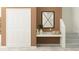 Stylish hallway featuring a modern mirror, accent table, and view of the carpeted staircase at 11118 E 65Th Ter, Palmetto, FL 34221