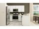 Kitchen with stainless steel appliances, white cabinets, and granite countertops next to dining area at 11118 E 65Th Ter, Palmetto, FL 34221