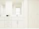 Bright bathroom featuring dual sinks with white cabinets and a large mirror at 11817 Blue Diamond Trl, Parrish, FL 34219