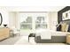 Bright bedroom with large windows, neutral tones, stylish furniture, and modern decor at 11817 Blue Diamond Trl, Parrish, FL 34219