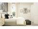 Bright bedroom featuring stylish bedding, neutral tones, sporty decor and a view to the outdoors at 11817 Blue Diamond Trl, Parrish, FL 34219