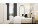 Serene bedroom with a plush bed, decorative mirror, neutral color palette and natural light at 11817 Blue Diamond Trl, Parrish, FL 34219