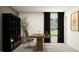 Modern home office featuring a wooden desk, sleek shelving unit, and large window with natural light at 11844 Blue Diamond Trl, Parrish, FL 34219
