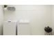 Laundry room with a side-by-side washer and dryer and wire shelving at 11844 Blue Diamond Trl, Parrish, FL 34219