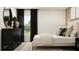 Comfortable bedroom showcasing a plush bed, dark dresser, window with curtains, and stylish decor at 11844 Blue Diamond Trl, Parrish, FL 34219