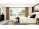 Sunlight streams into this bedroom with a black accent wall, neutral colors, and attractive furniture at 11844 Blue Diamond Trl, Parrish, FL 34219