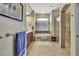 A bathroom featuring double sinks, a tub, and a glass door shower at 12012 Cromwell Way, Spring Hill, FL 34609