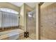 A bathroom featuring a bathtub and a glass door shower at 12012 Cromwell Way, Spring Hill, FL 34609
