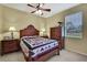 A bedroom with a wooden bed frame, dressers, and a ceiling fan at 12012 Cromwell Way, Spring Hill, FL 34609