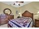 Bright bedroom featuring a wood bed frame with patriotic quilt at 12012 Cromwell Way, Spring Hill, FL 34609