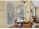 Inviting dining area with a glass table, surrounded by wooden chairs and with views to the outside patio at 12012 Cromwell Way, Spring Hill, FL 34609