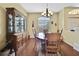 Spacious dining room with hardwood floors, large china cabinet, and arched window at 12012 Cromwell Way, Spring Hill, FL 34609