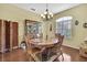 Dining room features hardwood floors and elegant chandelier at 12012 Cromwell Way, Spring Hill, FL 34609