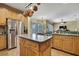 Large kitchen with stainless steel appliances, island, and view into the Gathering room at 12012 Cromwell Way, Spring Hill, FL 34609