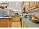 Well-equipped kitchen with stainless steel appliances, wood cabinets, and breakfast bar seating at 12012 Cromwell Way, Spring Hill, FL 34609