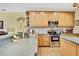 Well-lit kitchen with wood cabinets, stainless steel appliances, and spacious countertop for modern cooking at 12012 Cromwell Way, Spring Hill, FL 34609