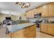 Open kitchen with stainless steel appliances, center island, and view to living area at 12012 Cromwell Way, Spring Hill, FL 34609