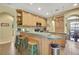 A kitchen with wood cabinets, a breakfast bar with seating, and stainless steel appliances at 12012 Cromwell Way, Spring Hill, FL 34609
