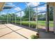 Enclosed lanai with a concrete floor and a clear view of the green backyard and blue skies at 12012 Cromwell Way, Spring Hill, FL 34609