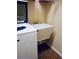 This laundry room has a white utility sink next to the washing machine at 12012 Cromwell Way, Spring Hill, FL 34609