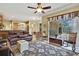 A living room with a leather couch, rocking chairs, and a rug at 12012 Cromwell Way, Spring Hill, FL 34609