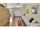 Inviting entryway with hardwood floors, white sofa, and view to the front door and dining room at 12012 Cromwell Way, Spring Hill, FL 34609
