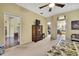 Bright bedroom with a ceiling fan, en suite bathroom, and walk-in closet for maximum comfort and convenience at 12012 Cromwell Way, Spring Hill, FL 34609