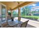 A screened patio with a table, chairs, and a ceiling fan at 12012 Cromwell Way, Spring Hill, FL 34609