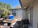 Enclosed backyard featuring a quaint patio area, side door, a small window and trees at 12049 132Nd Ave, Seminole, FL 33778