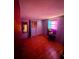 Another purple-walled bedroom featuring paneled floors and a window to let in natural light at 12049 132Nd Ave, Seminole, FL 33778