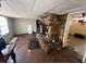 Spacious living room featuring a striking stone fireplace and bright, airy atmosphere at 12049 132Nd Ave, Seminole, FL 33778