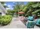 Inviting backyard with lush tropical foliage, seating area, perfect for relaxing and entertaining outdoors at 1210 Bay Palm Blvd, Indian Rocks Beach, FL 33785