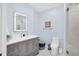 Bathroom featuring modern fixtures, an illuminated mirror, and a glass-enclosed shower for a spa-like experience at 1210 Bay Palm Blvd, Indian Rocks Beach, FL 33785