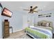 Comfortable bedroom with a ceiling fan, TV, and wicker accents at 1210 Bay Palm Blvd, Indian Rocks Beach, FL 33785
