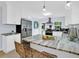 Modern kitchen with stainless steel appliances, granite countertops, and a spacious island with seating at 1210 Bay Palm Blvd, Indian Rocks Beach, FL 33785