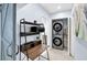 Functional laundry area with stacked washer and dryer and a convenient workspace at 1210 Bay Palm Blvd, Indian Rocks Beach, FL 33785