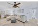Comfortable living room with a plush sectional sofa, modern ceiling fan, and an inviting open-concept design at 1210 Bay Palm Blvd, Indian Rocks Beach, FL 33785