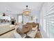 Bright and airy living room with a dining area, modern lighting, and comfortable seating at 1210 Bay Palm Blvd, Indian Rocks Beach, FL 33785