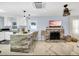 Open-concept living room and kitchen with modern finishes, stone fireplace, and ample natural light at 1210 Bay Palm Blvd, Indian Rocks Beach, FL 33785
