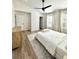Large primary bedroom with wood-look floors, and two large windows for natural light at 12334 Country White Cir, Tampa, FL 33635