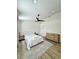 Spacious bedroom with a ceiling fan, wood-look flooring and neutral paint at 12334 Country White Cir, Tampa, FL 33635