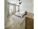 Bright bedroom with a ceiling fan, two windows and wood-look flooring at 12334 Country White Cir, Tampa, FL 33635